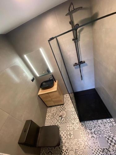 a bathroom with a toilet and a cross on the wall at Chouciña Apartments in Sanxenxo