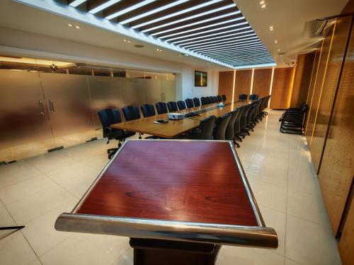 a conference room with a long table and chairs at Sylhet Paradise Inn in Sylhet