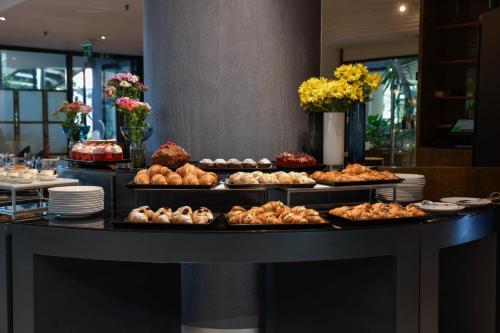 a buffet with several trays of food on a table at The Nicolaus Hotel in Bari