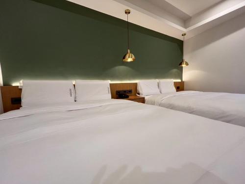 Ένα ή περισσότερα κρεβάτια σε δωμάτιο στο Fooyee Hotel Wenxin Zhongqing