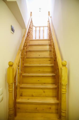 a staircase with wooden steps in a house at Gomi 20 in Tbilisi City