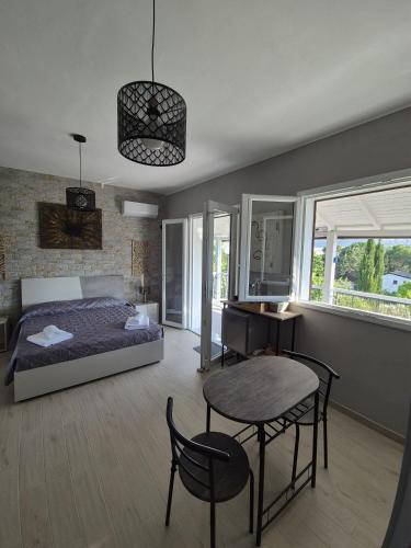 a bedroom with a bed and a table and chairs at Chalet Ponte Paradiso Suite & SPA in Santa Cristina Gela