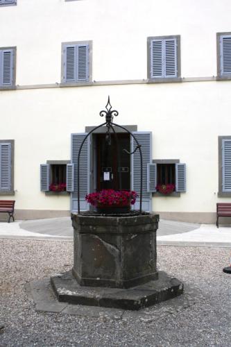 a fountain with flowers in front of a building at Villa Montarioso in Siena