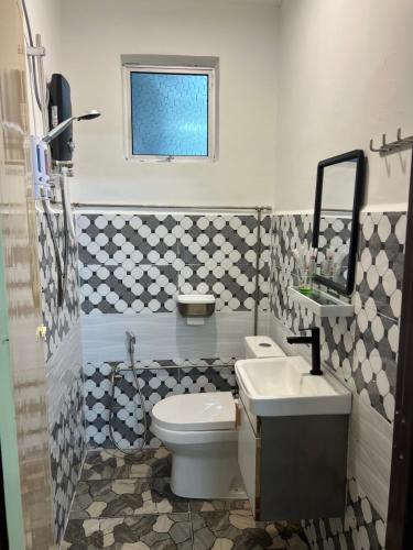 a bathroom with a toilet and a sink at Rumah No 5 in Taiping