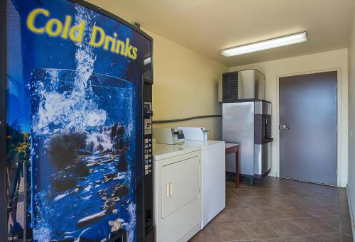 a kitchen with a cold drink refrigerator in a room at Quality Inn Calhoun North I-75 in Calhoun