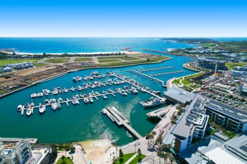 an aerial view of a marina with boats in the water at Seabreeze on the Beach in Barrack Point