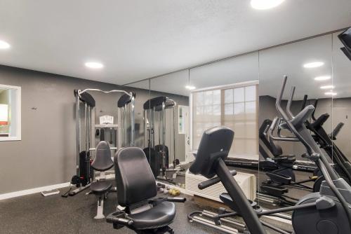 a gym with a row of tread machines and mirrors at MainStay Suites Denver Tech Center in Centennial