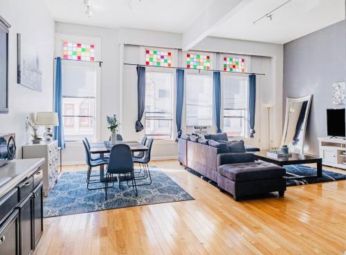 a living room with a couch and a table at Greely Gaslamp - Loft W Parking & 4 Beds #201 in San Diego