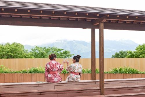 two women in kimonos standing on a deck at Hotel Yumeshizuku in Minami Aso