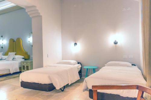 a hospital room with two beds and a table at Hotel Caribe by Faranda Grand, a member of Radisson Individuals in Cartagena de Indias