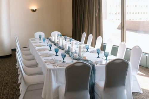 a long table with white chairs and white tablecloths at Radisson Hotel Duluth-Harborview in Duluth