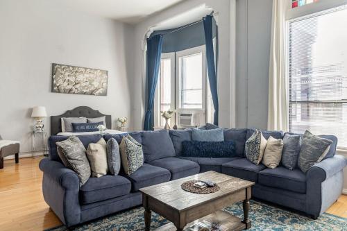 a blue couch in a living room with a table at Free Parking Loft Suite Walk to Conv Center in San Diego