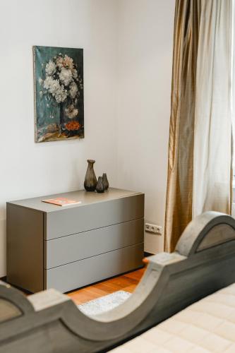 a dresser with a vase on it in a bedroom at My Wonderland in Salzburg