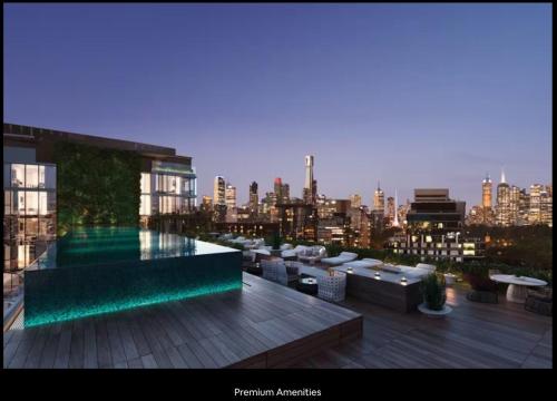 a rooftop patio with a view of a city at Executive Two bedroom & two bathrooms in Melbourne