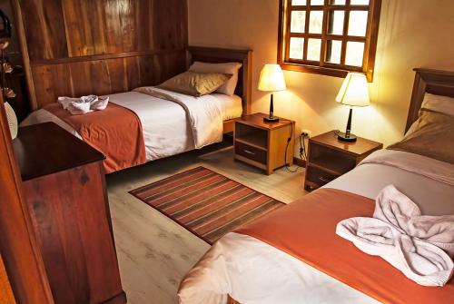 Кровать или кровати в номере The Wooden House Hotel