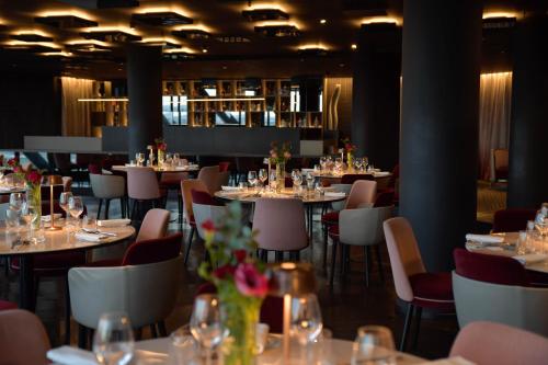 a dining room with tables and chairs with wine glasses at The Nicolaus Hotel in Bari
