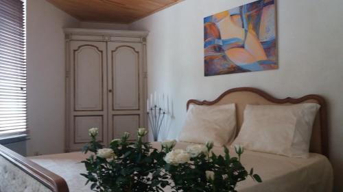 a bedroom with a bed with white flowers on it at Golden Lion in Bouillon