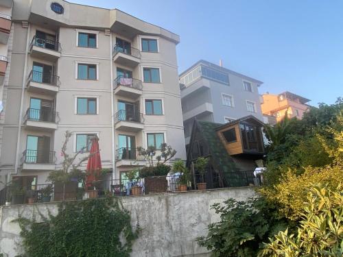 a tall apartment building with balconies on a wall at SİMGE Apt in Trabzon