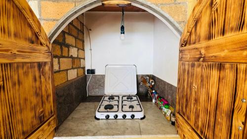a kitchen with a stove top oven in a room at Finca Maradentro - private pool and jacuzzi with ocean view in Arafo