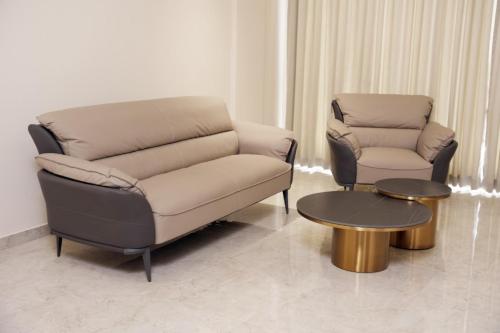 a living room with a couch and a chair and a table at Alba Regency in Guruvāyūr