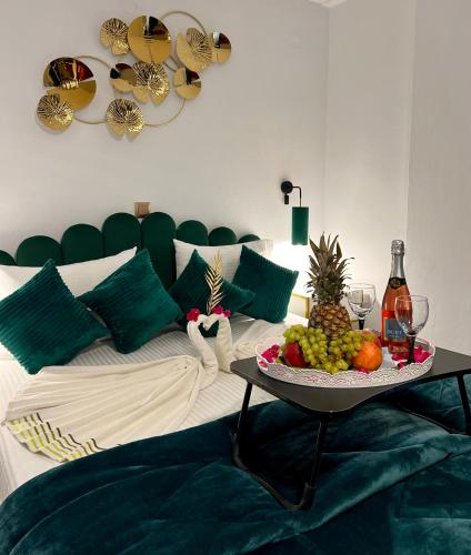 a room with a bed with a tray of fruit on a table at Bella Vista in Balíon