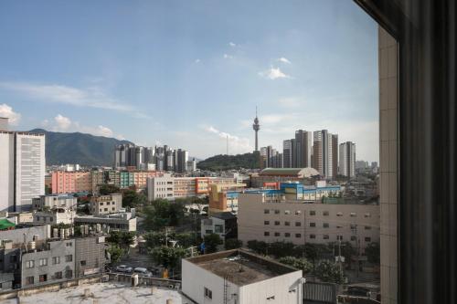 a view of a city from a window at Crystal Hotel Daegu in Daegu