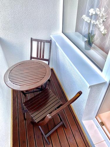 a table and a chair sitting next to a window at Cozy & comfortable place in city centre in Tartu