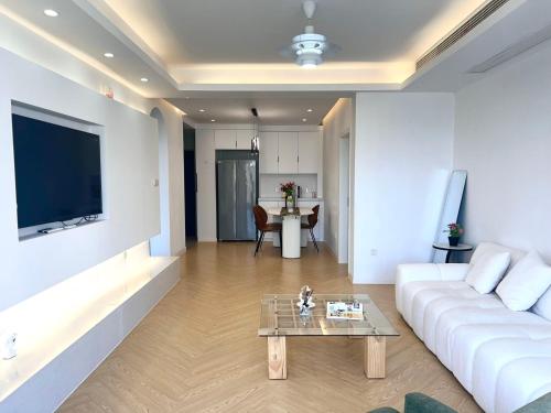 a living room with a white couch and a table at Urban Hub Near the Bund nice view big apartment 2bathrooms in Shanghai