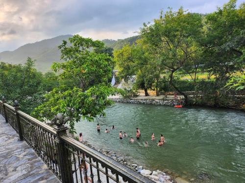 a group of people swimming in a river at Jasmine Retreat 