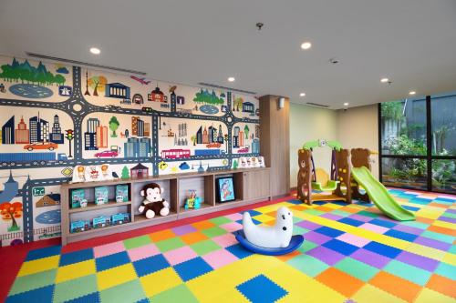 a childs room with a play area with a playground at Luwansa Hotel and Convention Center Manado in Manado