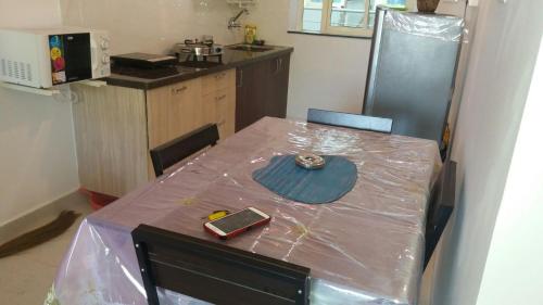 a kitchen with a table with plastic on it at Ocean Shores Hospitality in Candolim