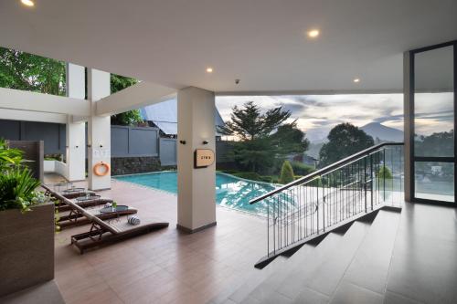 a large house with a swimming pool and a balcony at Luwansa Hotel and Convention Center Manado in Manado