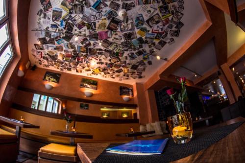 a restaurant with a wall covered in photos at Hotel Blaue Ecke in Adenau