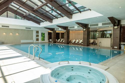 a large pool with a hot tub in a building at Spa Hotel Persenk in Devin