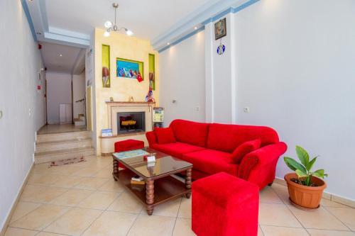 a living room with a red couch and a table at Balkan House in Potos
