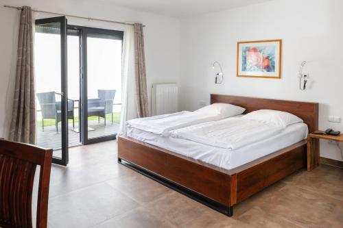 a bedroom with a bed and a balcony at Aalto Hotel in Hannover