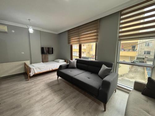 a living room with a couch and a bed at SİMGE Apt in Trabzon