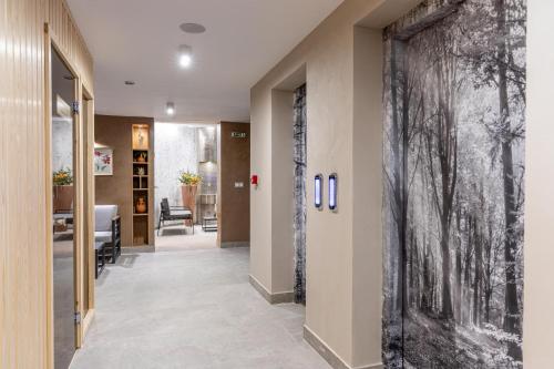a hallway with a large black and white painting on the wall at Spa Hotel Persenk in Devin