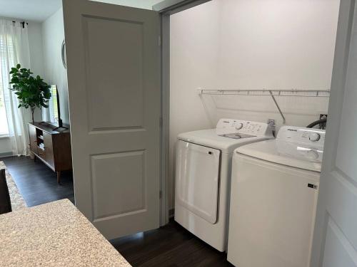 a white laundry room with a washer and dryer at Spotless Remote Work Flat Pool Fast Wifi in Dublin
