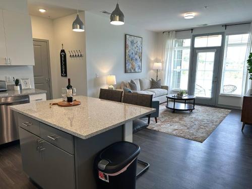 a kitchen and living room with a island in a kitchen at Spotless Remote Work Flat Pool Fast Wifi in Dublin