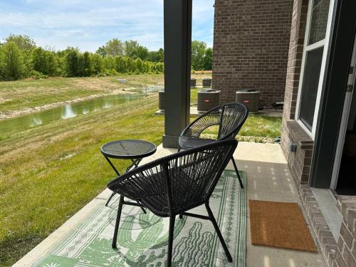 two chairs and a table on a porch at Spotless Remote Work Flat Pool Fast Wifi in Dublin