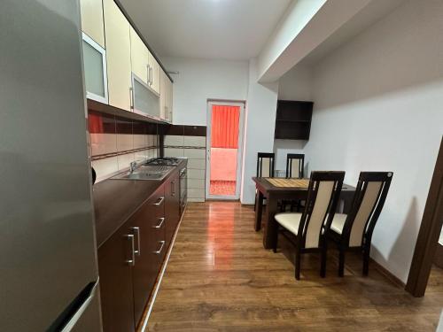 a kitchen with a table and chairs and a dining room at Zlata Nordic Residence 16a in Suceava