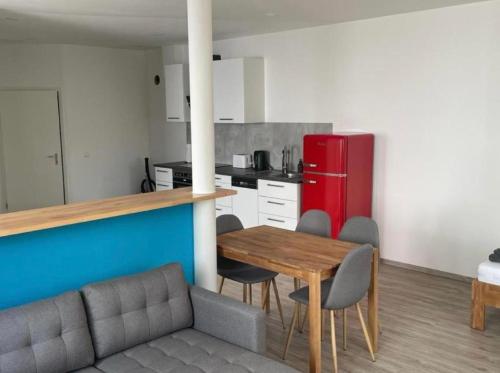 a kitchen with a table and chairs and a red refrigerator at Haus Gerda in Neustadt an der Weinstraße
