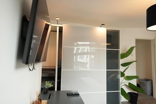 a glass cabinet with a television on top of it at Cozy Urban Escape 2BR near Greenwich & Deptford in London