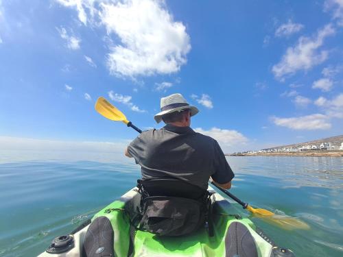 a man is paddling a kayak in the water at West Coast Rock in St Helena Bay