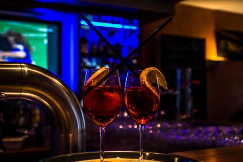 two glasses of red wine sitting on a bar at Hotel Blaue Ecke in Adenau