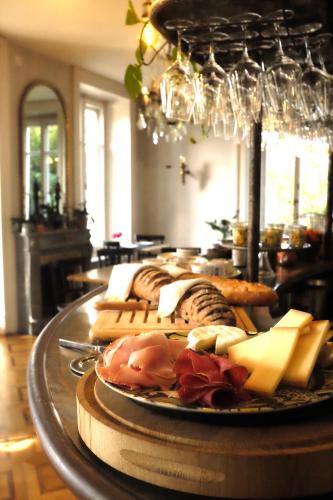 a plate of cheese and other foods on a table at La Maison d'Igor in Morges
