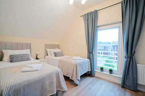 En eller flere senge i et værelse på Ošupio tako Lux Vilos with Free Parking