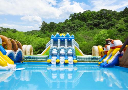 a water park with a water slide in the water at OakValley Resort Hills Village in Wonju