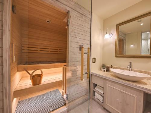 a bathroom with a sink and a shower at Auberge de Primavera in Karuizawa